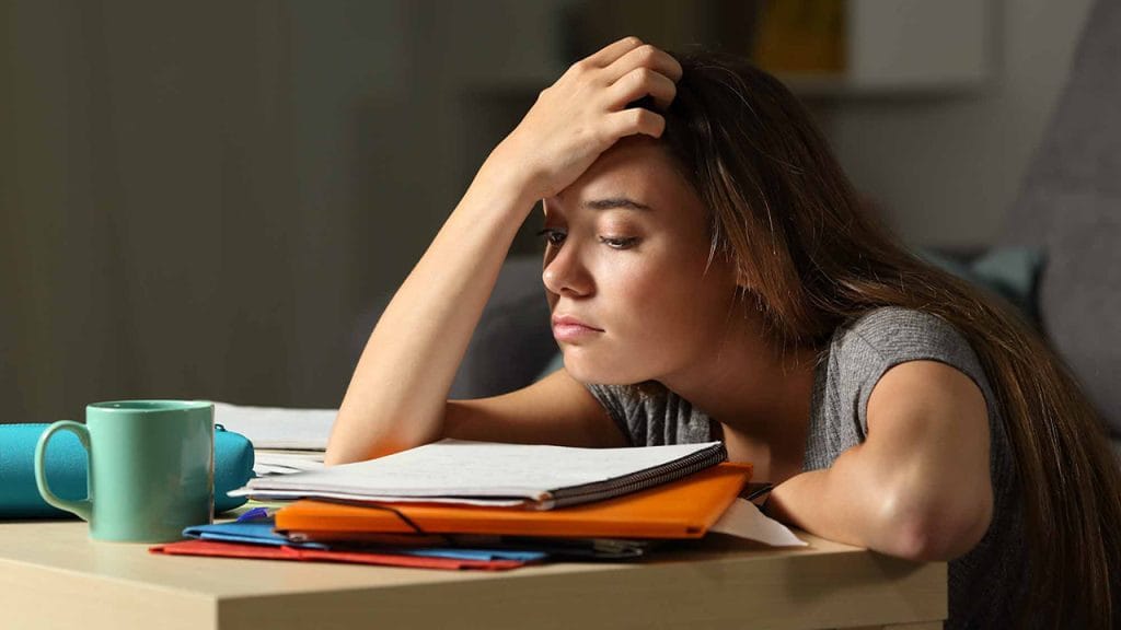 A frustrated student trying to study at home. She needs some motivation to learn English fast!
