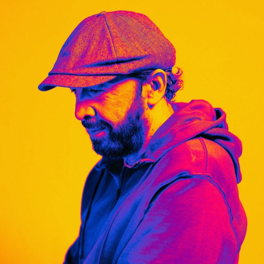 A vibrant promo shot of Juan Luis Guerra — the perfect reminder of how joyful it can be to learn Spanish with music through his storytelling and Caribbean sound.